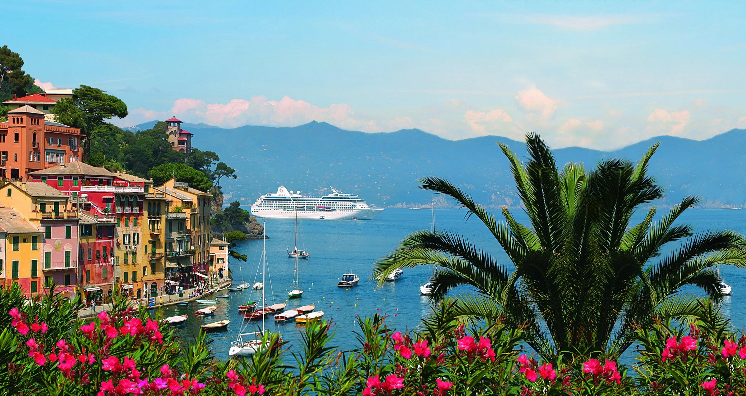 Oceania ship anchored off a colourful Riviera harbour