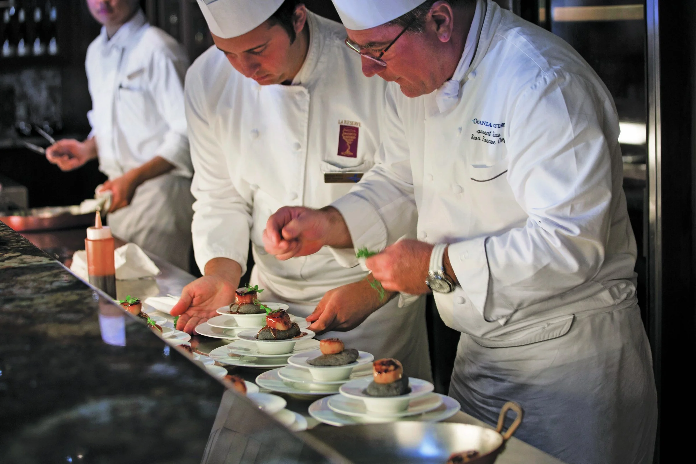 Oceania chefs plating a course