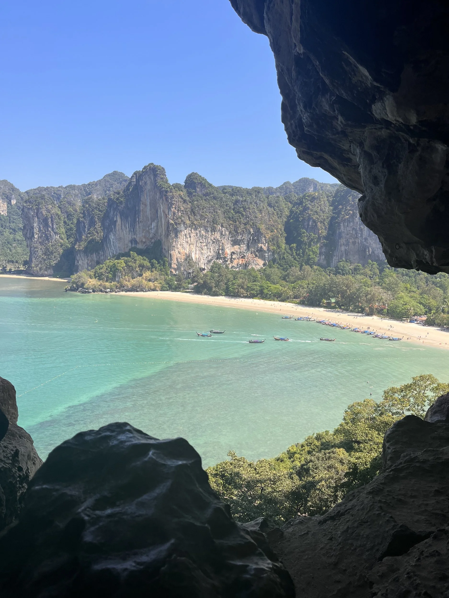 A turquoise bay seen from inside a cave above Railay
