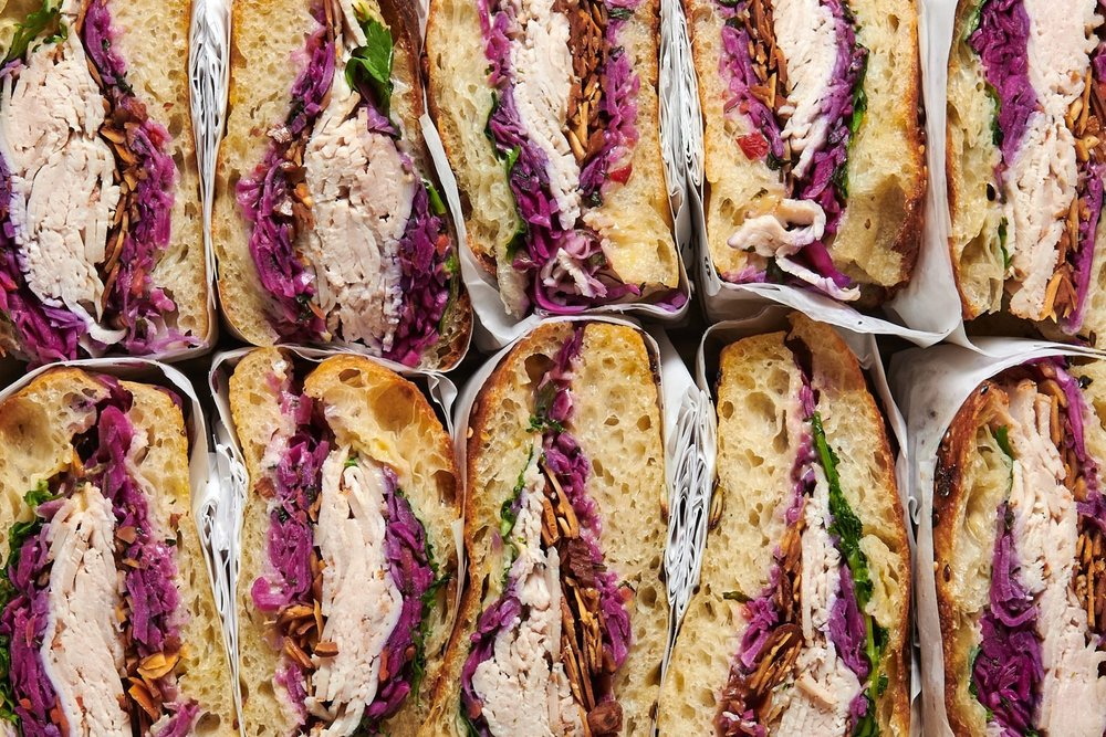 Roasted turkey sandwiches with red cabbage, wrapped for boxed lunch