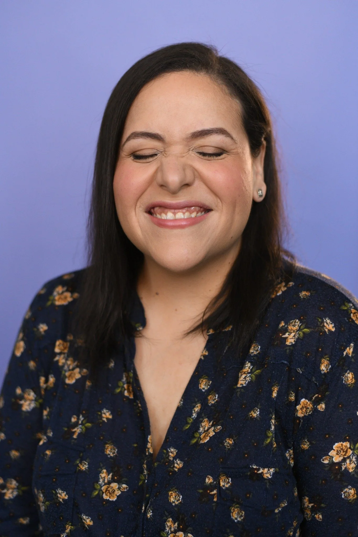 Villy grinning with her eyes closed during her headshot shoot.