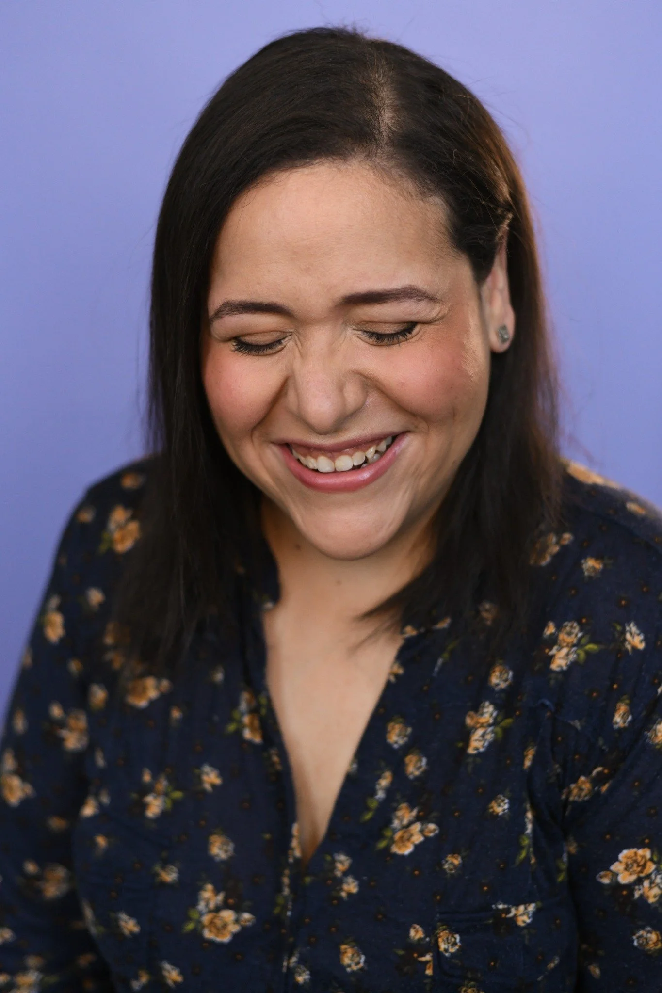Villy laughing with her eyes closed during her headshot shoot.