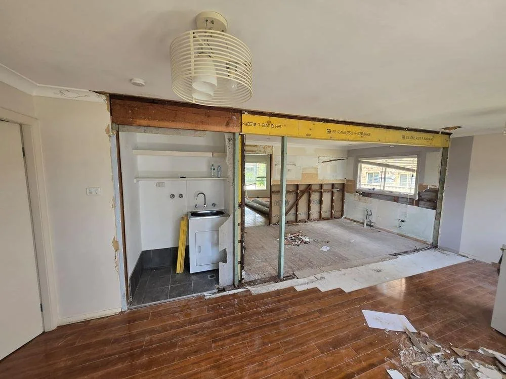 The original wall between the living room, laundry and kitchen