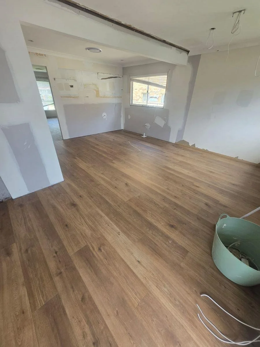 After: the opened-up room sheeted, set and finished with new flooring