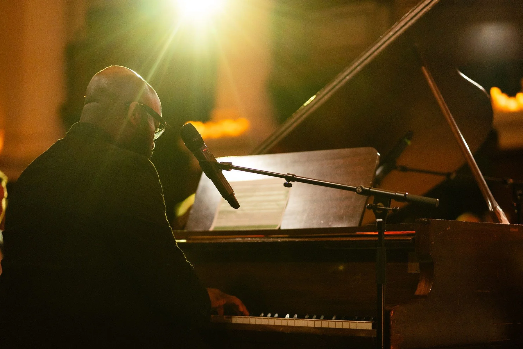 A pianist performing at a grand piano