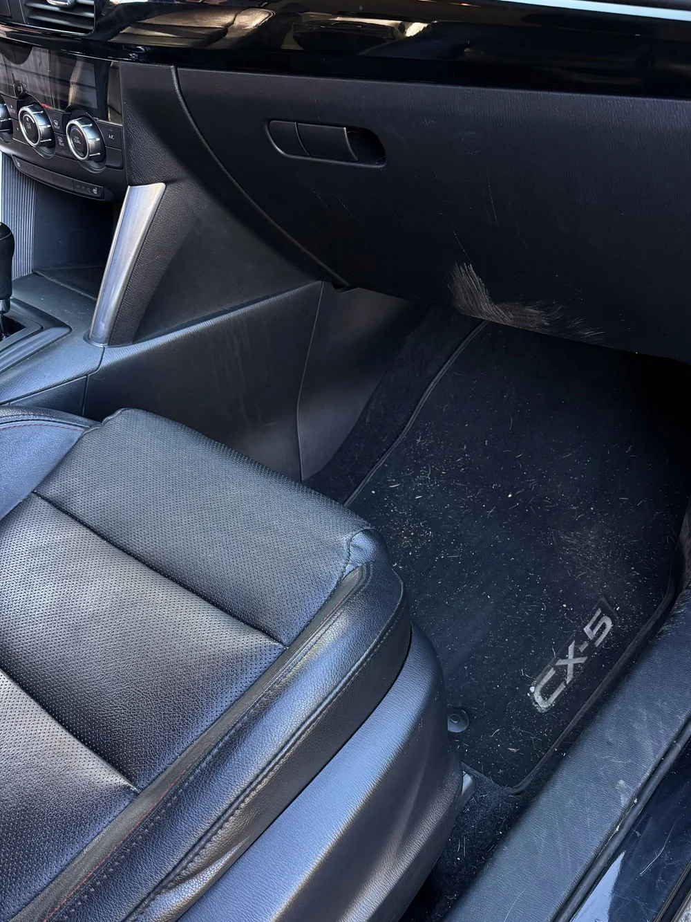 Dirty front passenger floor before interior detailing