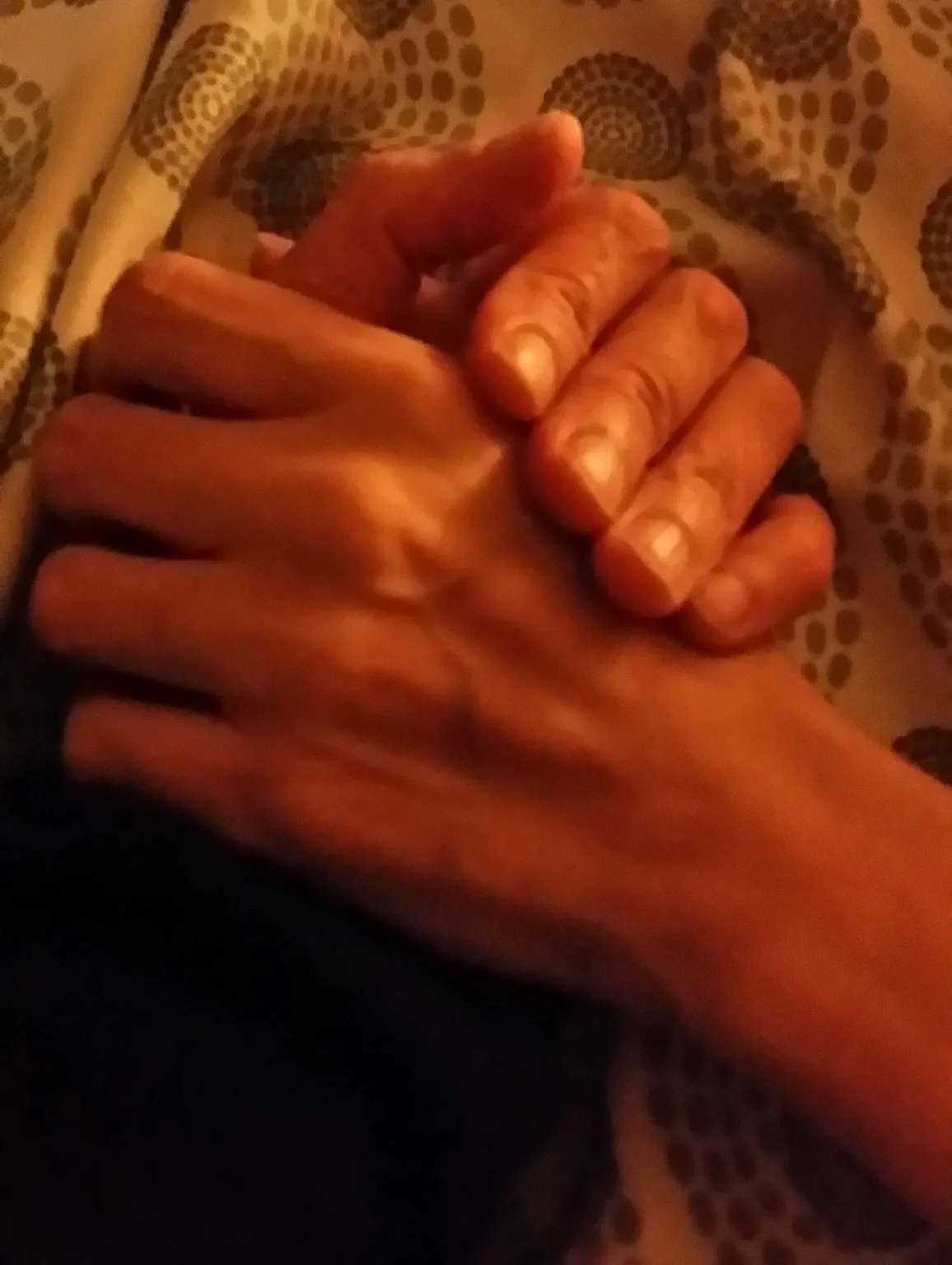 Close-up of two hands clasped together.