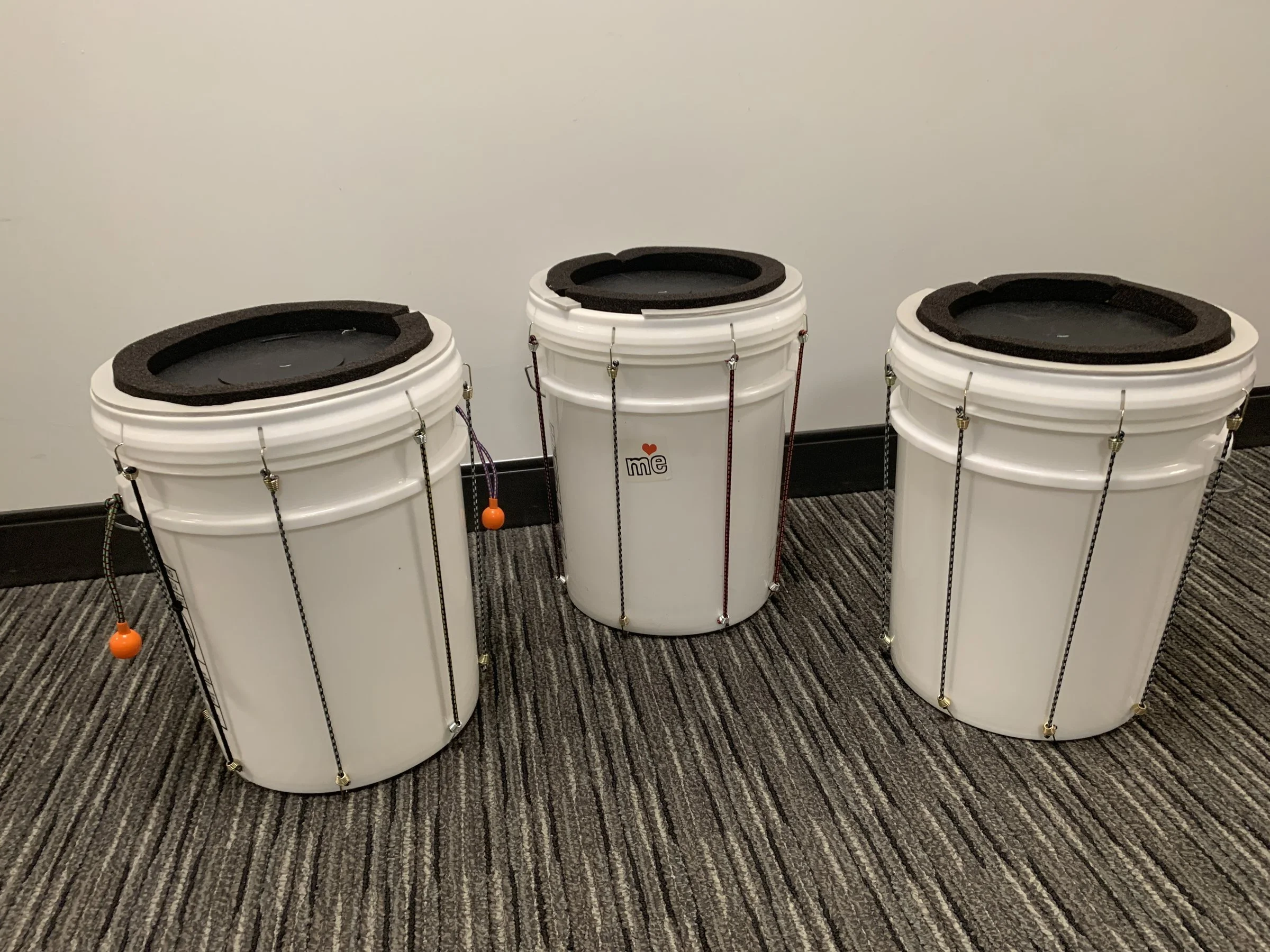 Three BOM bucket drums with foam rings and elastic lacing