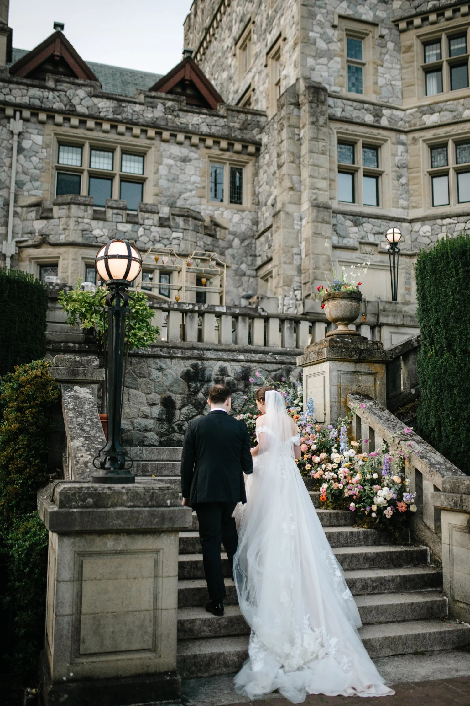 The couple walking up the castle stairs