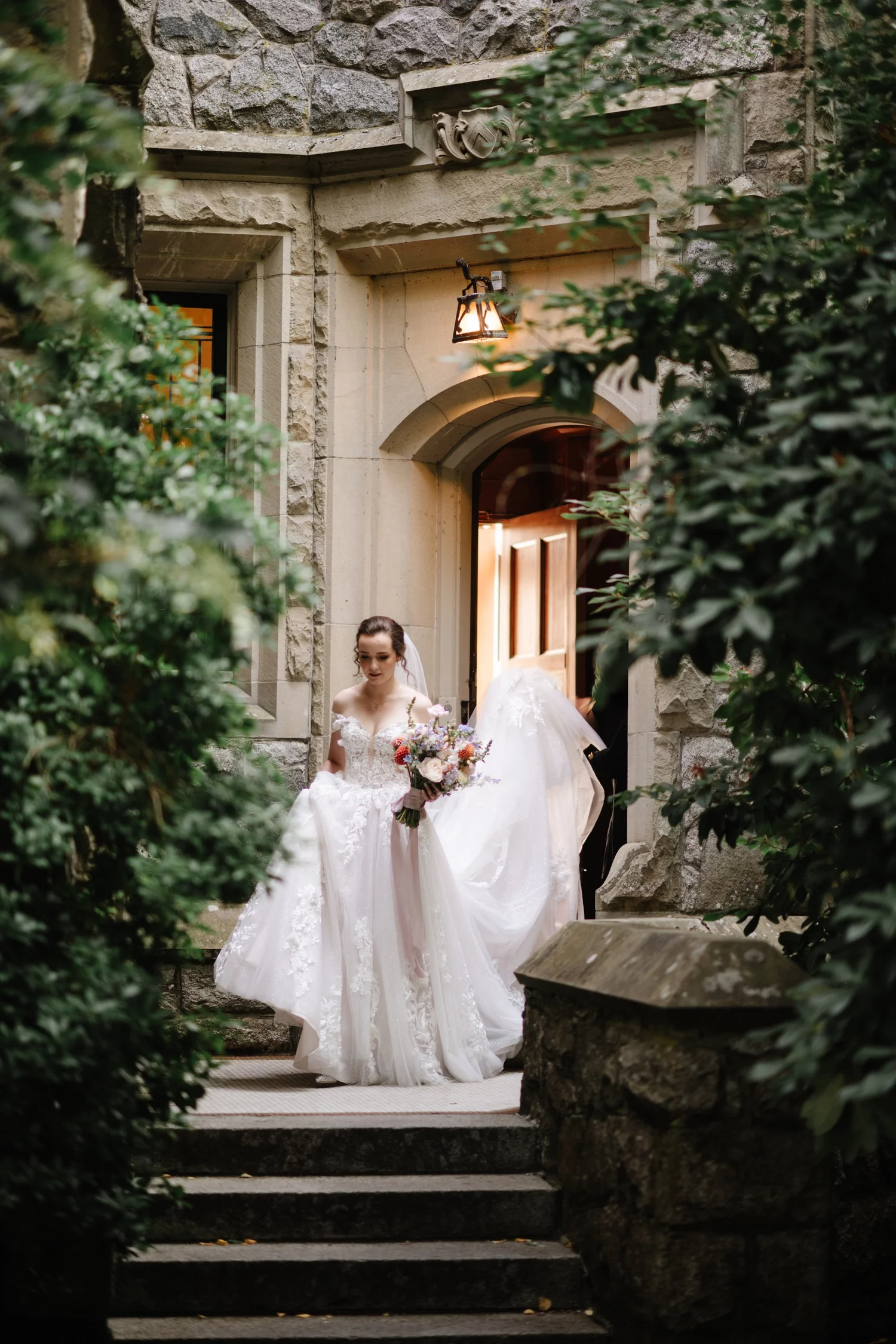 The bride stepping out of the castle