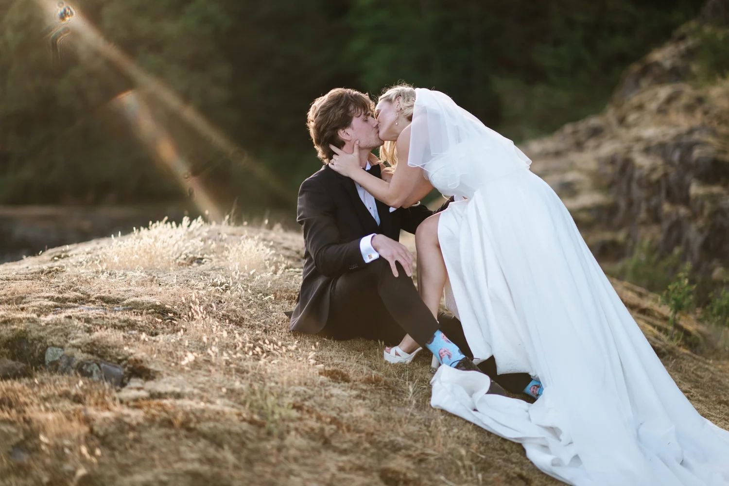 Megan and Devon embracing by the water