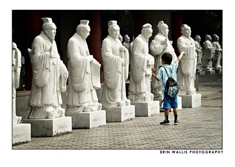 Boy telling statues where to go in Japan Boy pointing in Japan