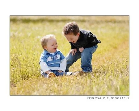 a good laugh two boys laughing in the grass