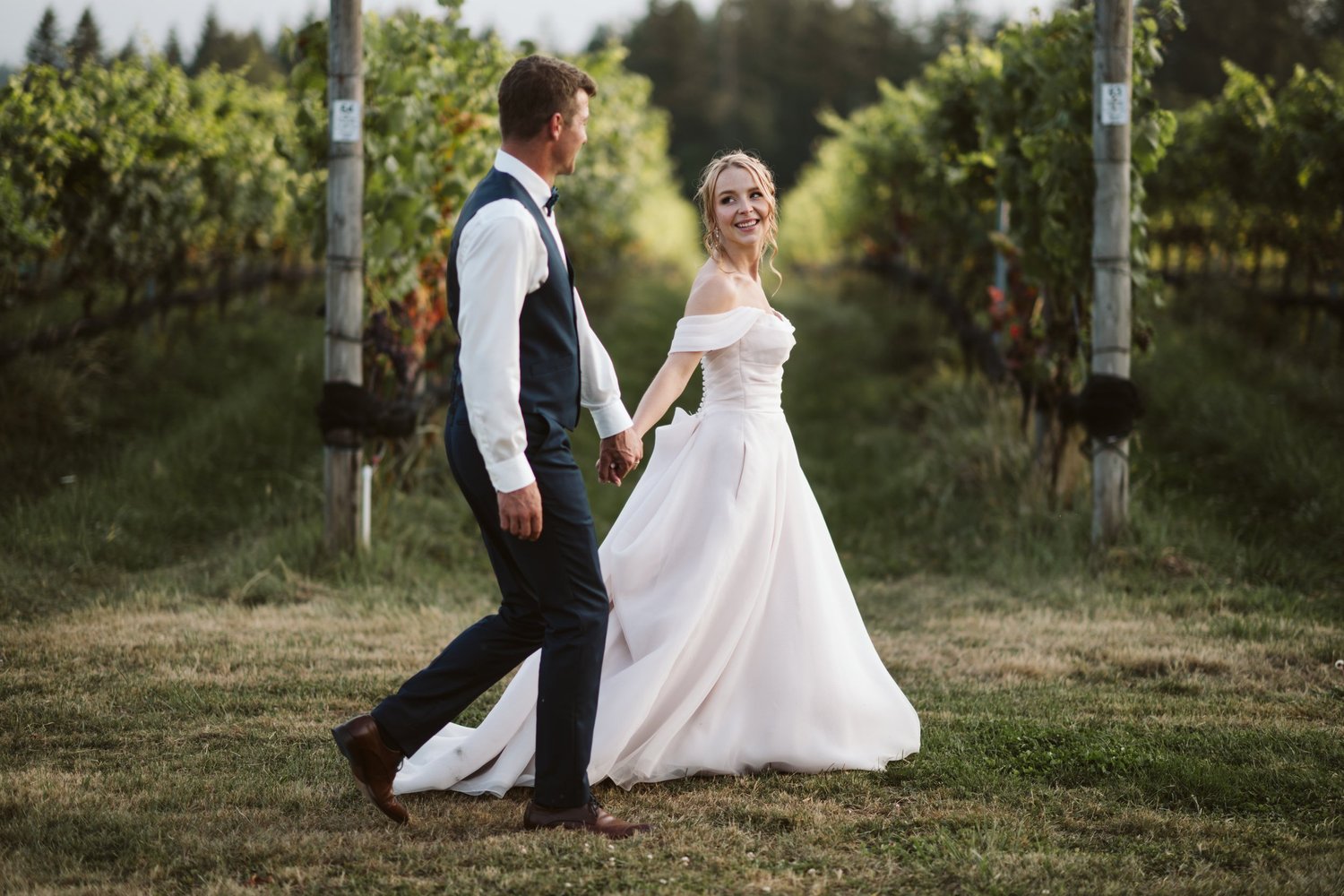 Charlie and Myles walking through the vines