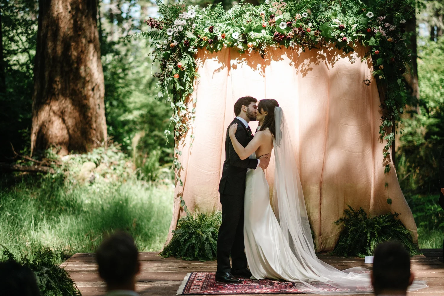 A kiss in front of the ceremony backdrop