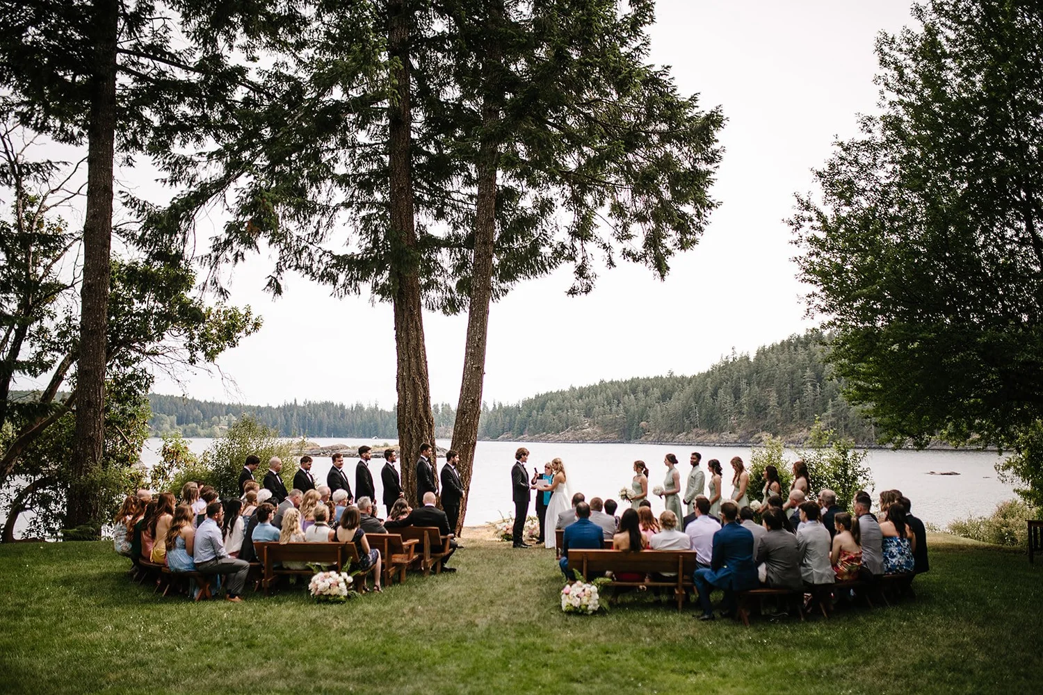The ceremony under the trees beside the water