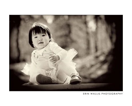 Little Gorgeous girl on a picnic table in a tutu