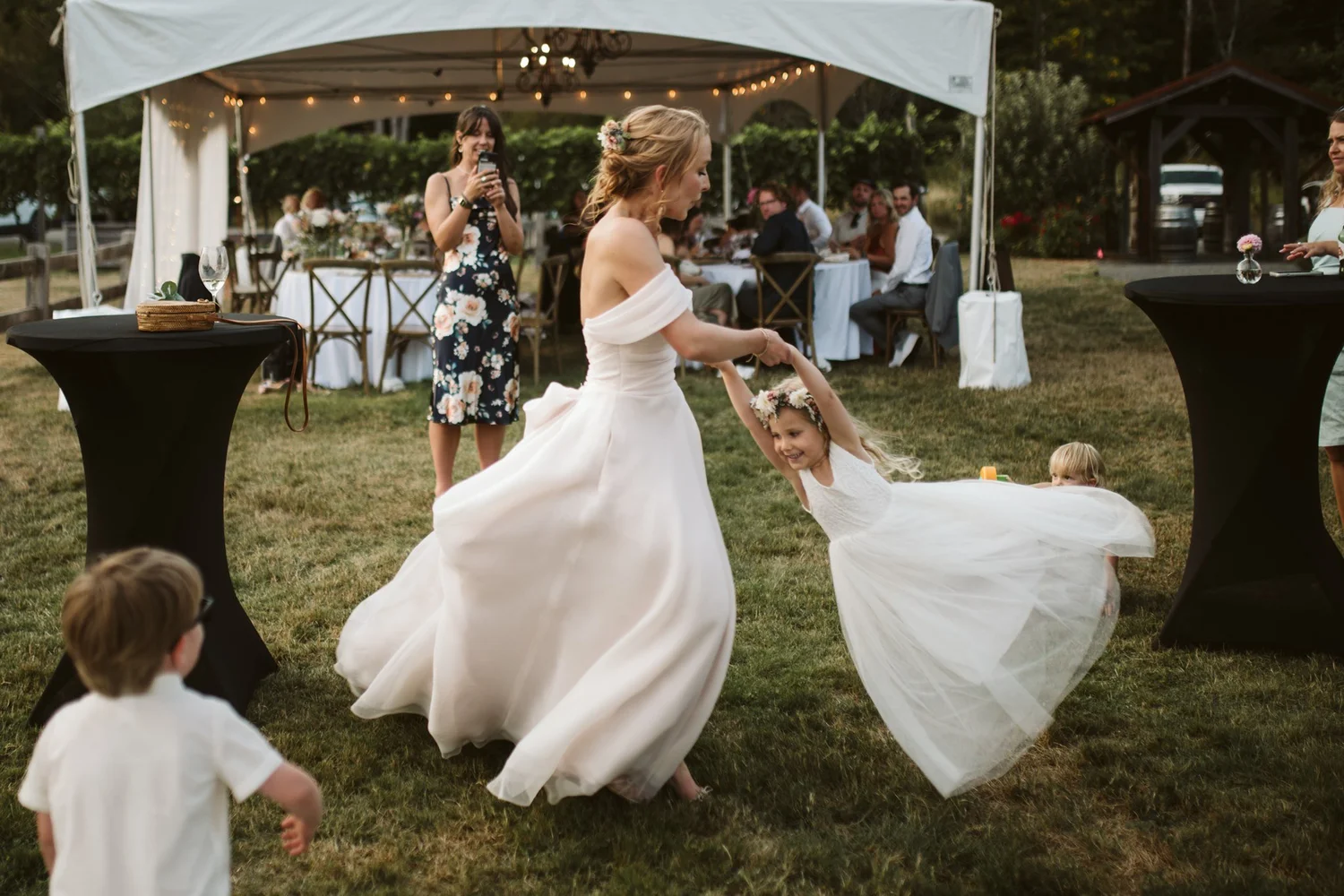 Charlie dancing with a little one on the lawn