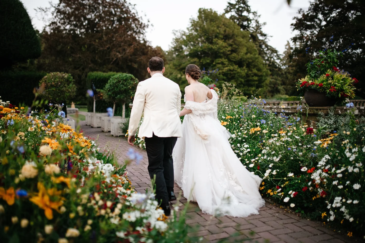 The couple walking through the gardens