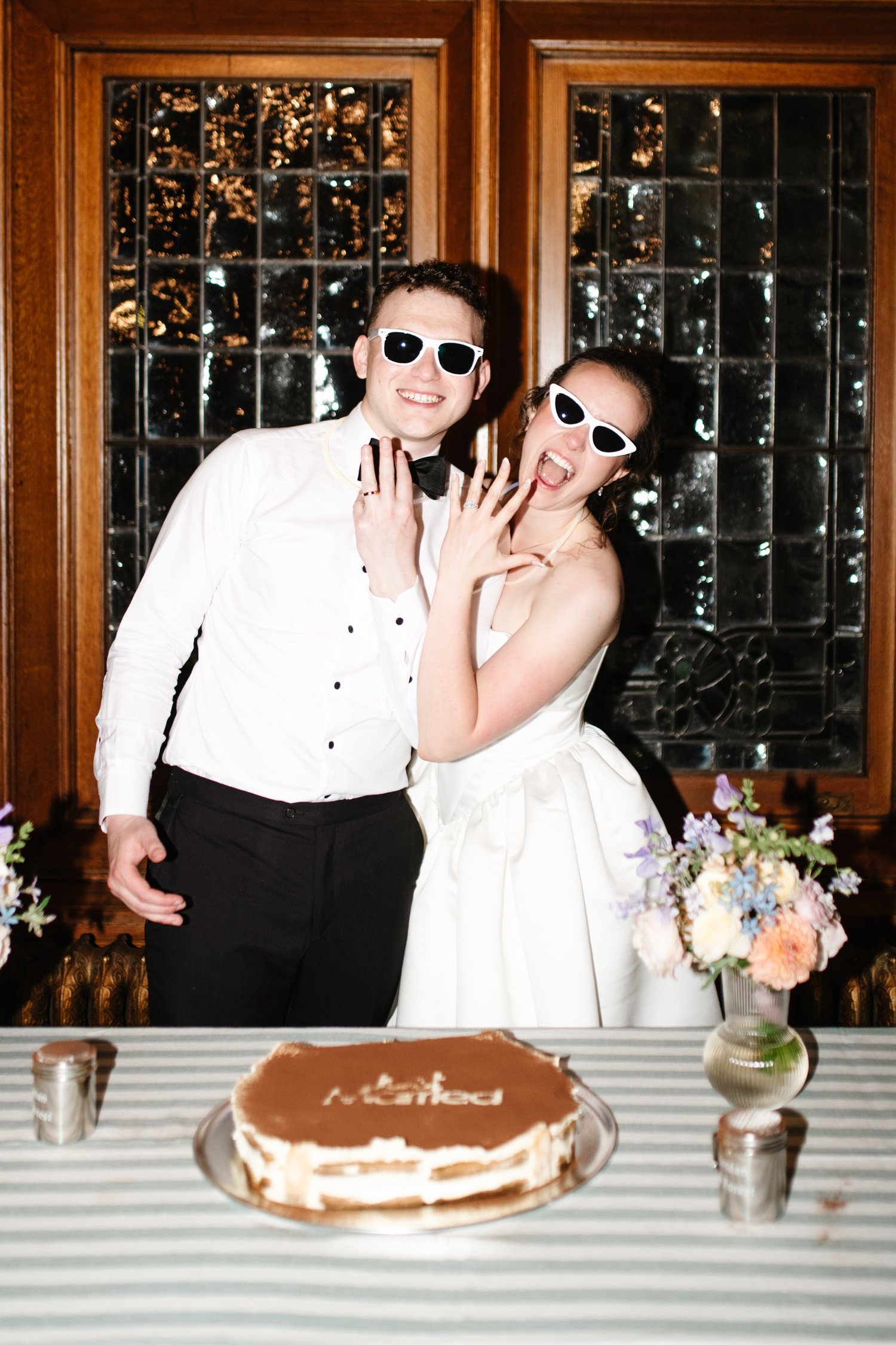 The couple in sunglasses at the cake table