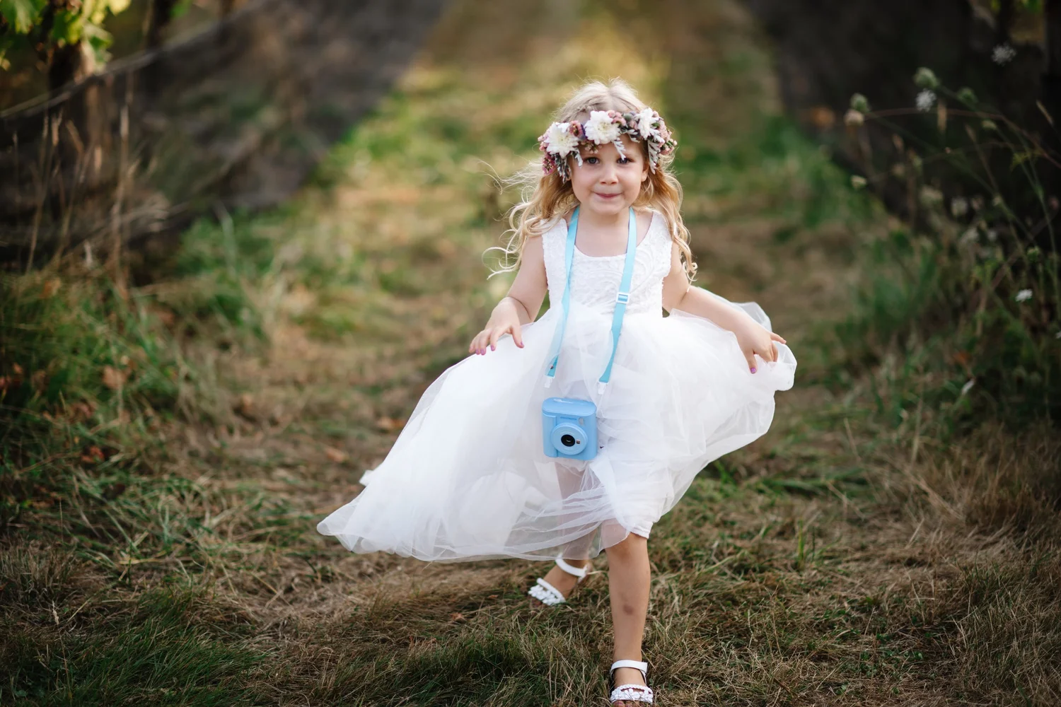 A flower girl running through the grass