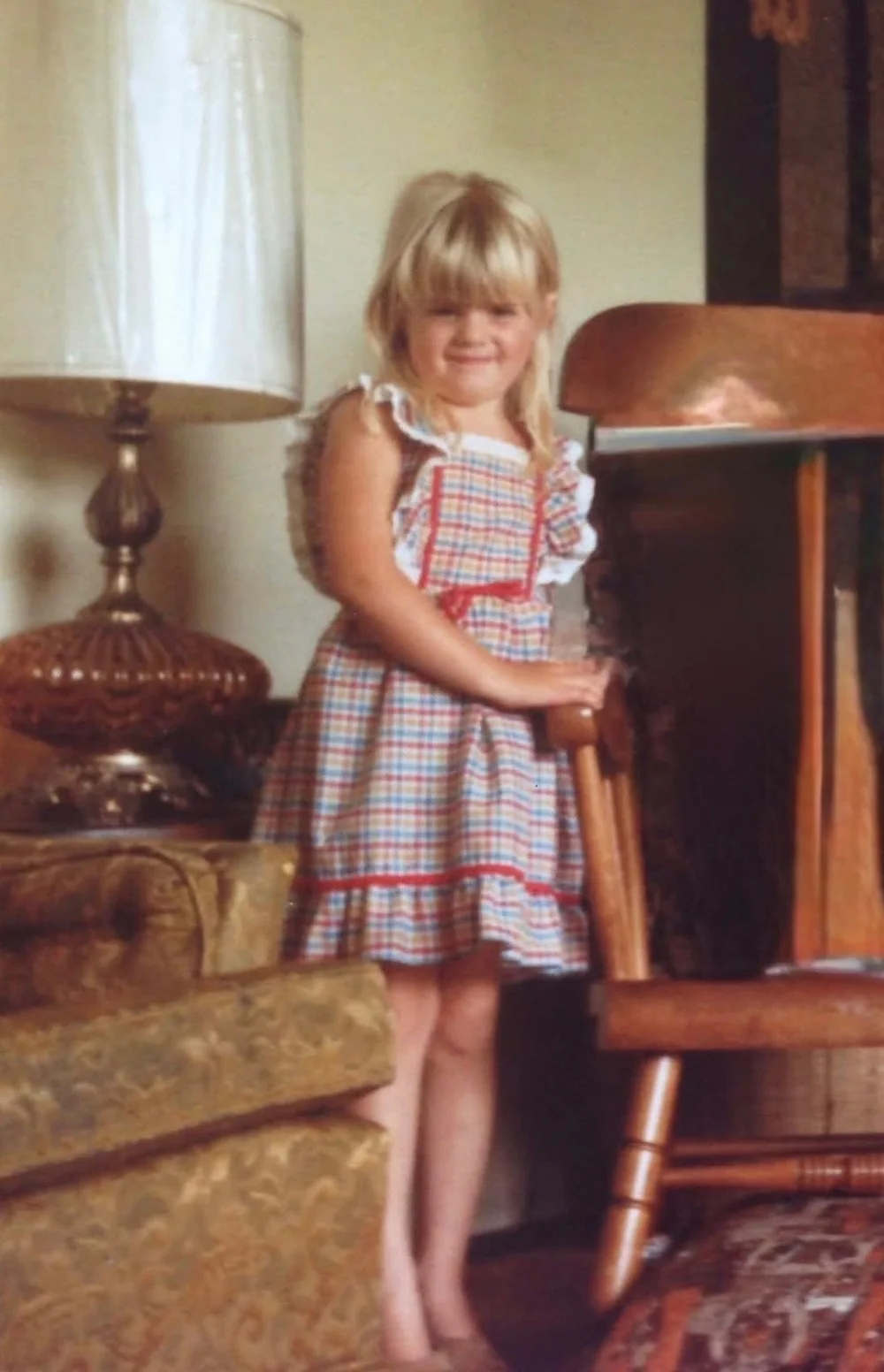 Erin as a little girl in a checked sundress