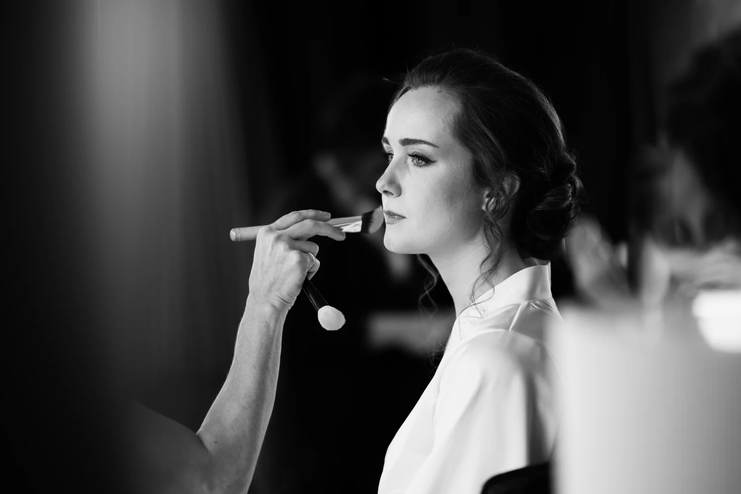 The bride having her makeup finished