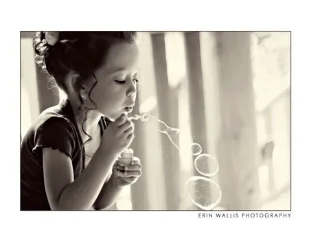 flower girl blowing bubbles