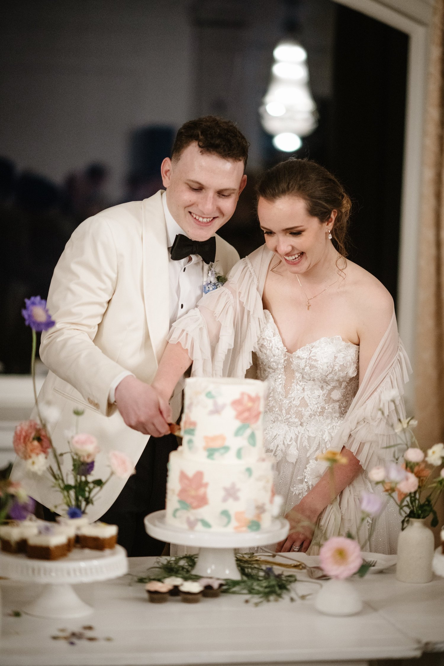 The couple cutting the cake