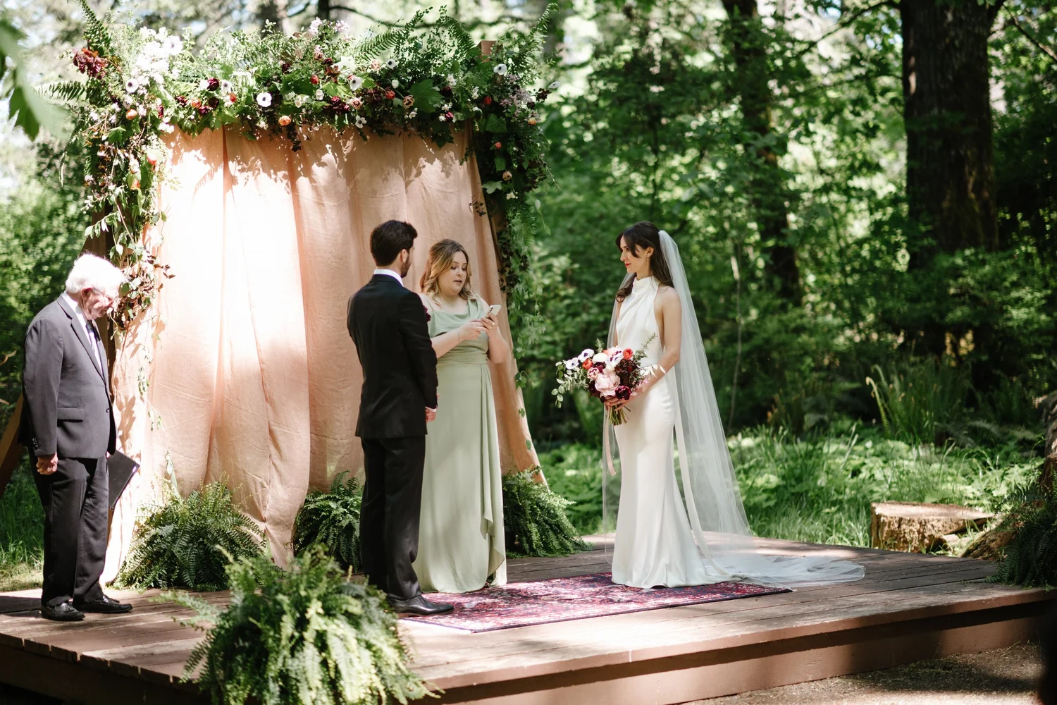 Dana and Cole at the ceremony among the trees