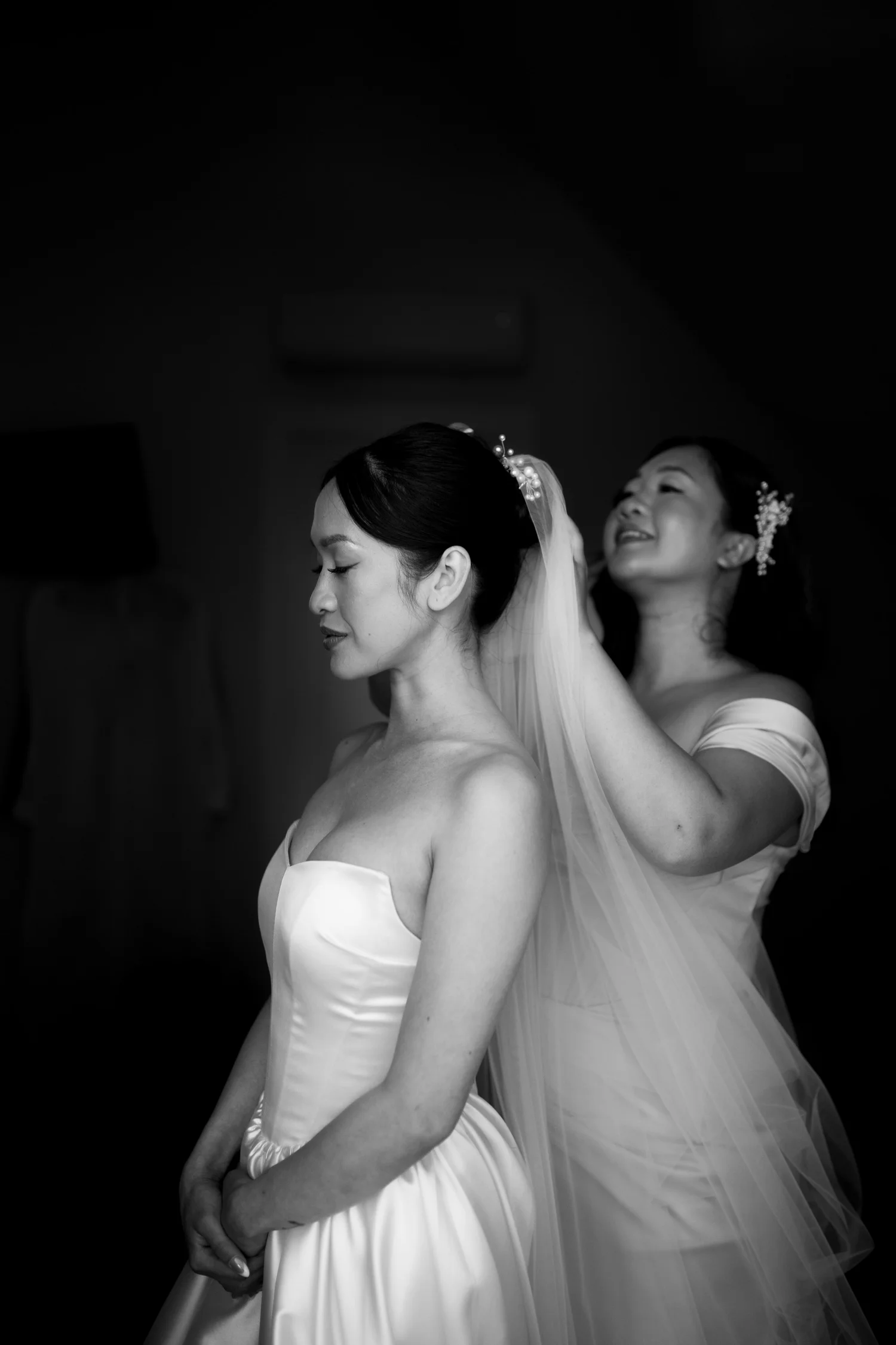 Rea having her veil placed, in black and white