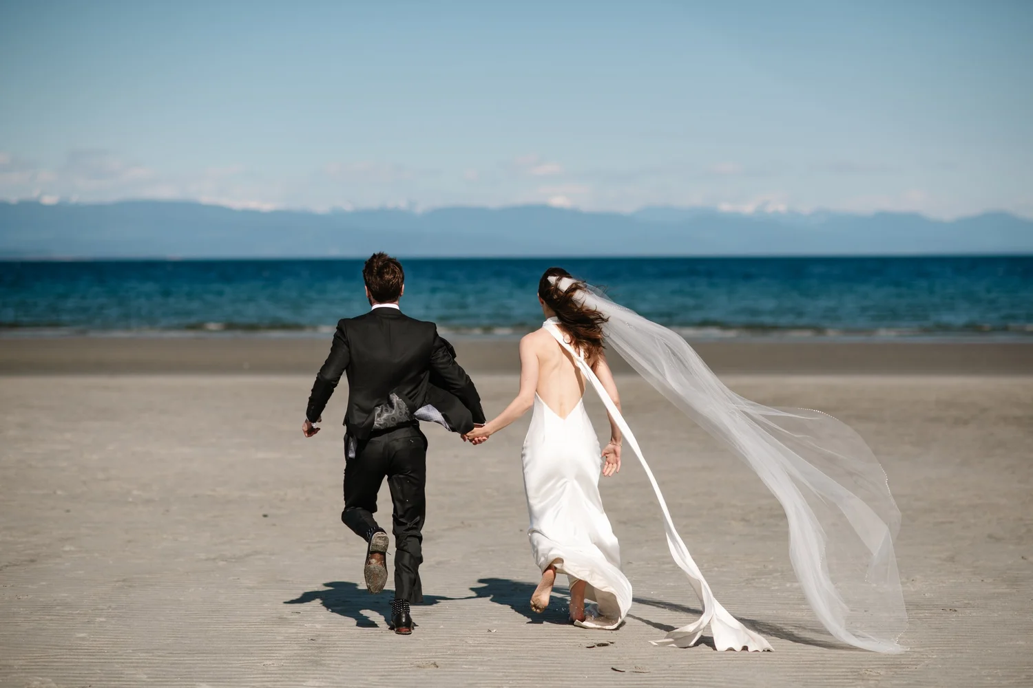 Dana and Cole walking toward the water