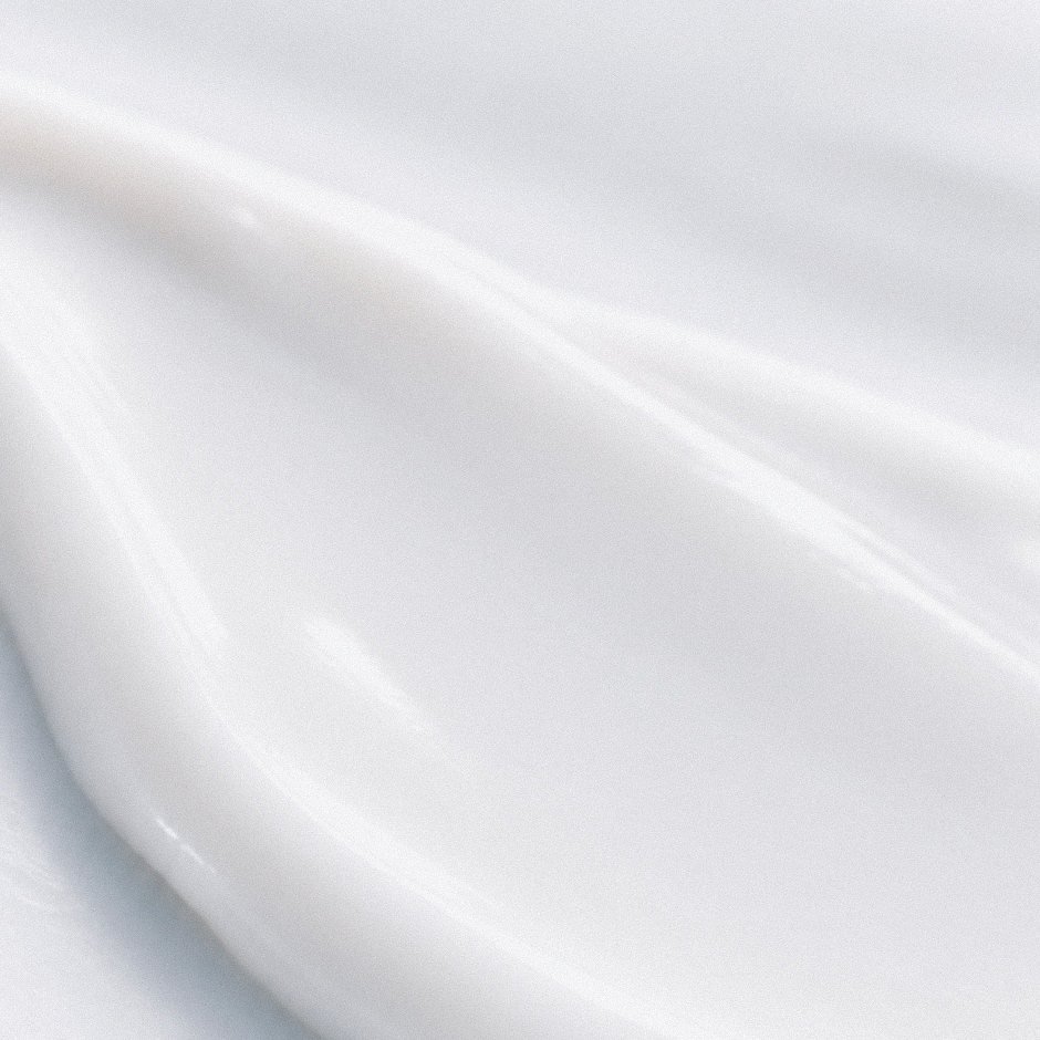 An extreme close-up of white cream, soft as silk.