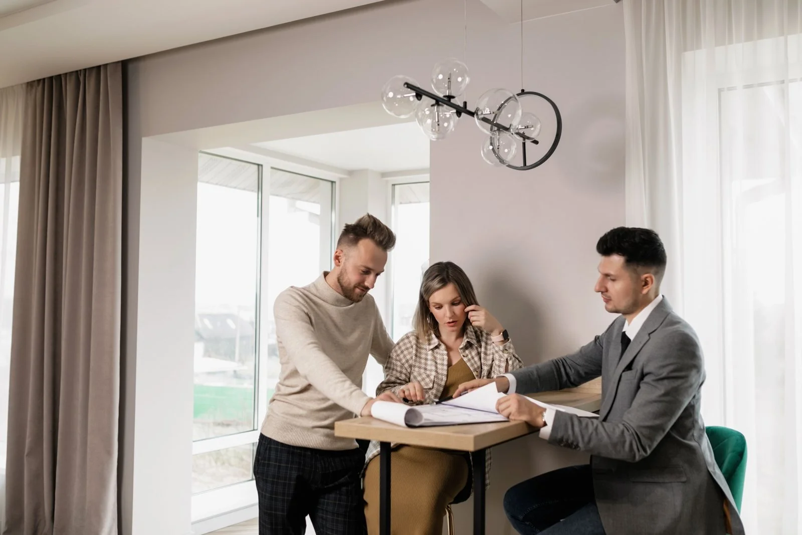 Professional explaining paperwork to a couple before signing