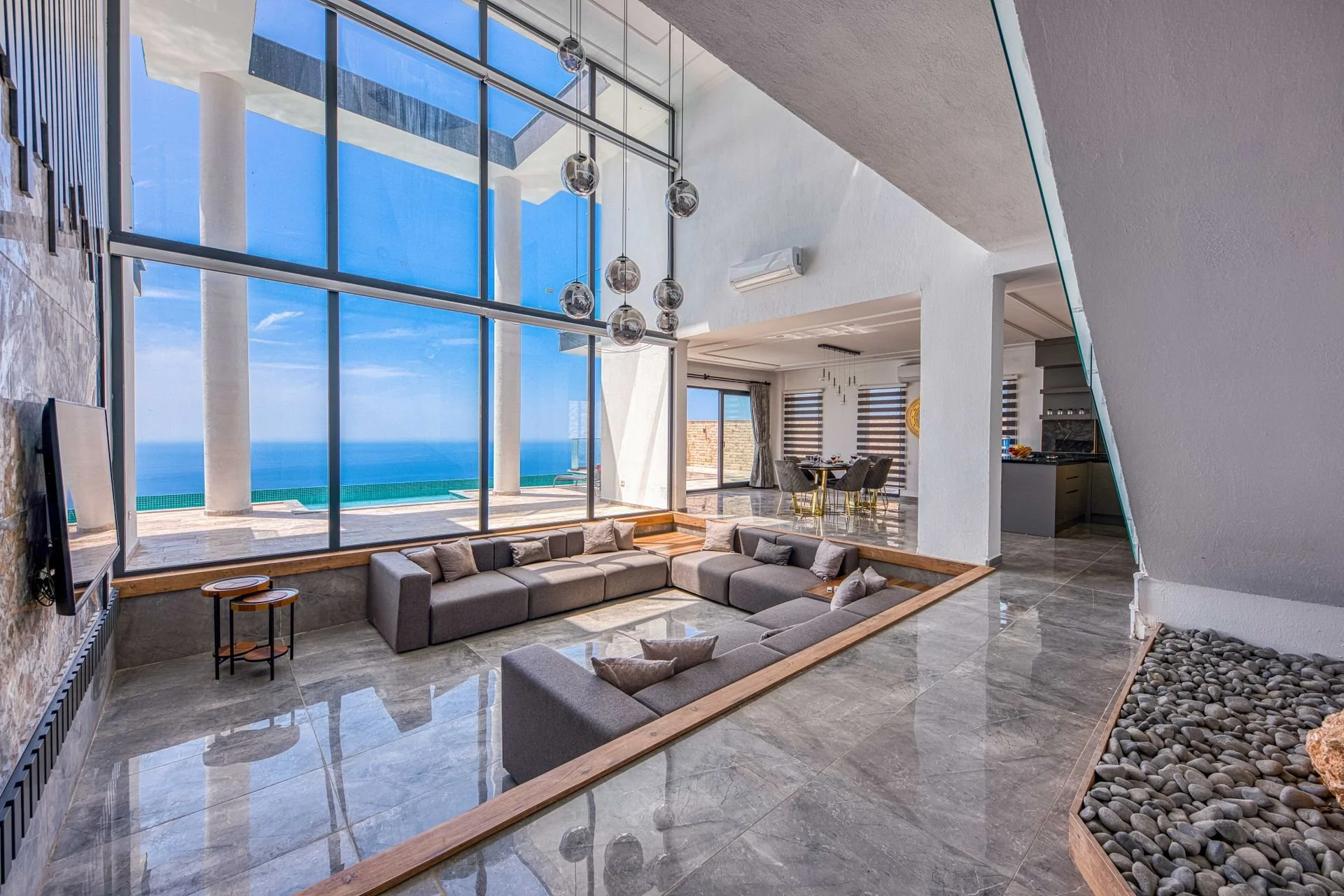 Bright contemporary living room with floor-to-ceiling sea views