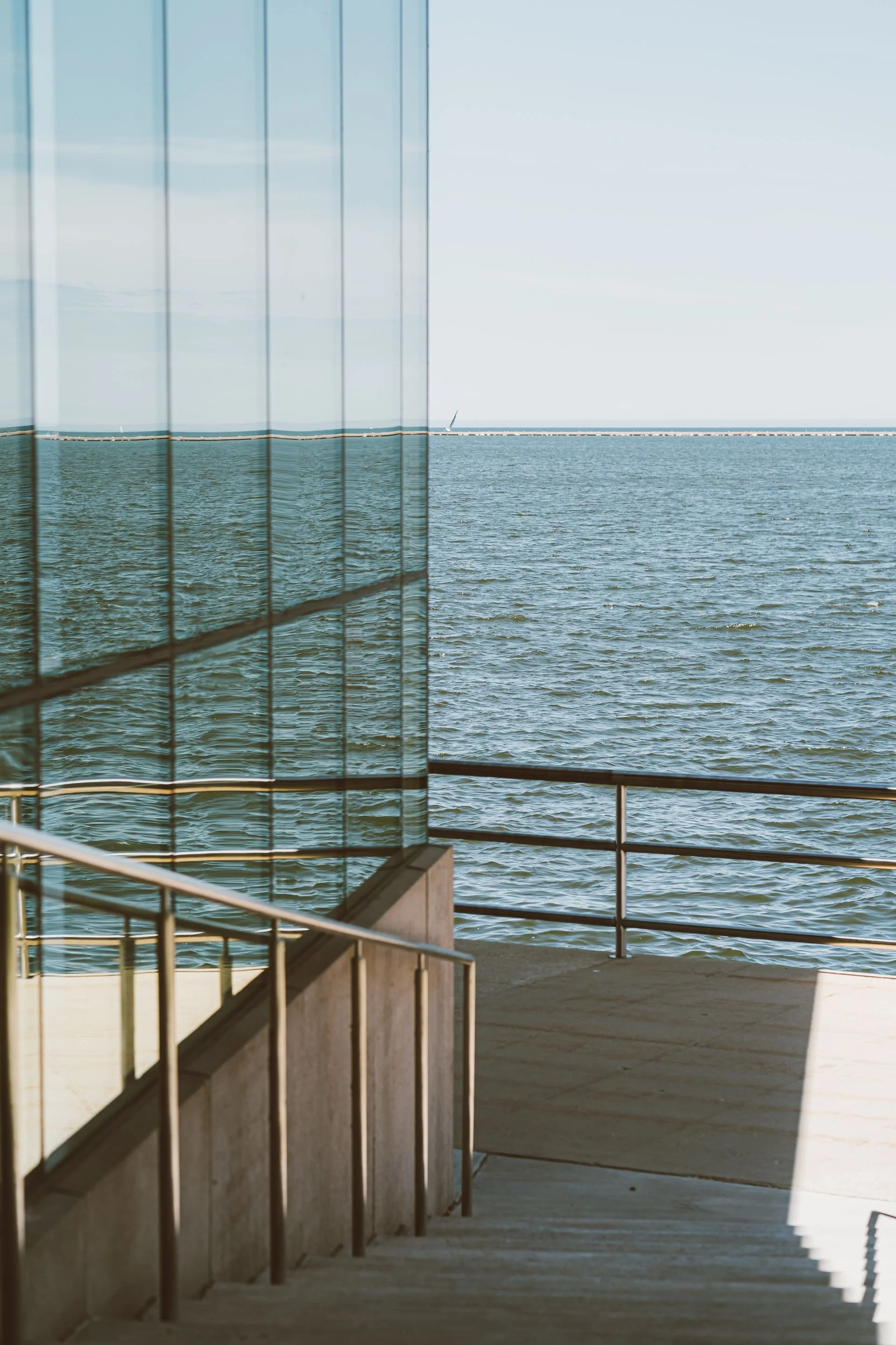Waterfront view framed by glass and contemporary architecture