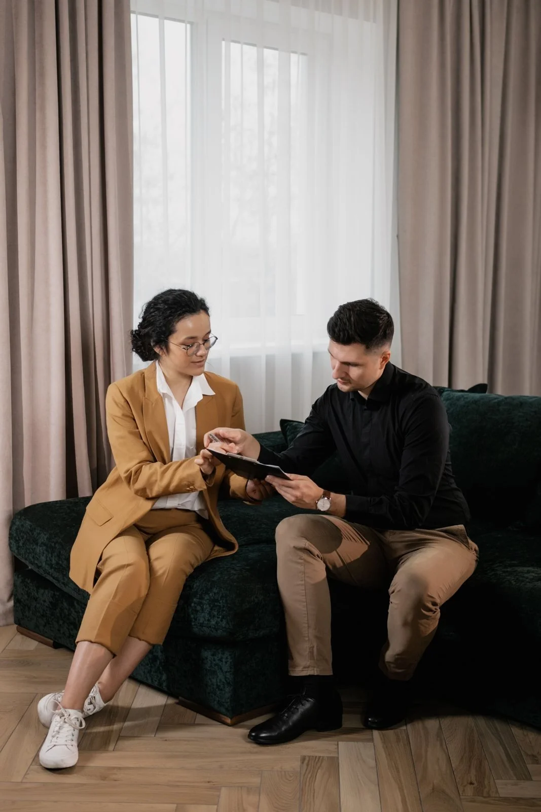 Two people discussing documents during a real estate consultation