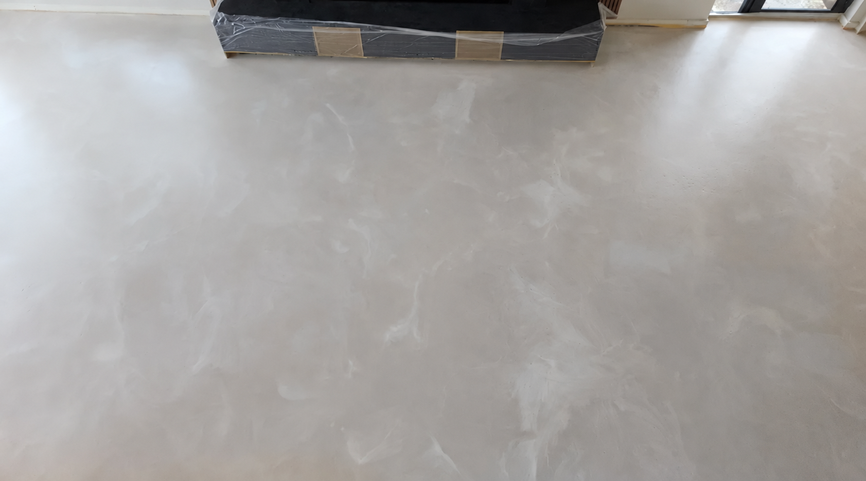 Pale decorative resin floor with subtle marble effects