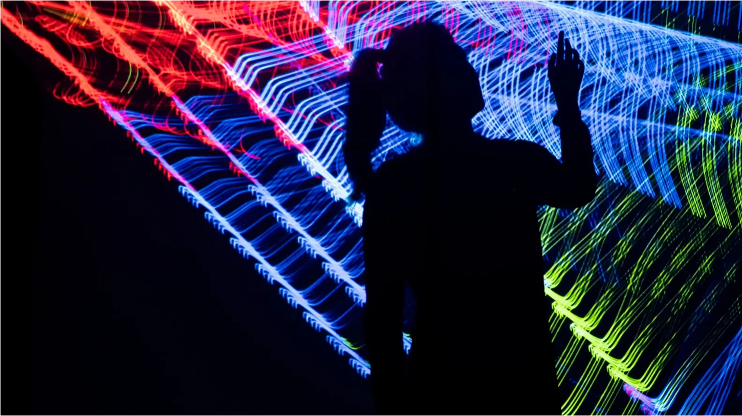 A silhouette against glowing light art