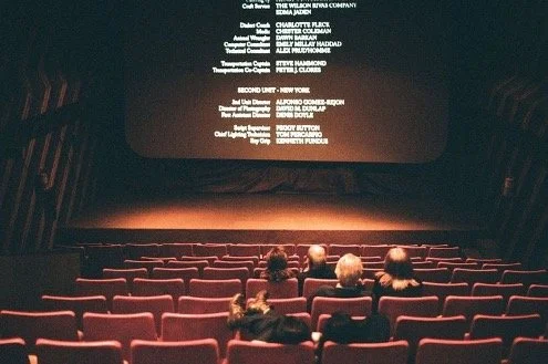 A packed cinema facing a glowing screen