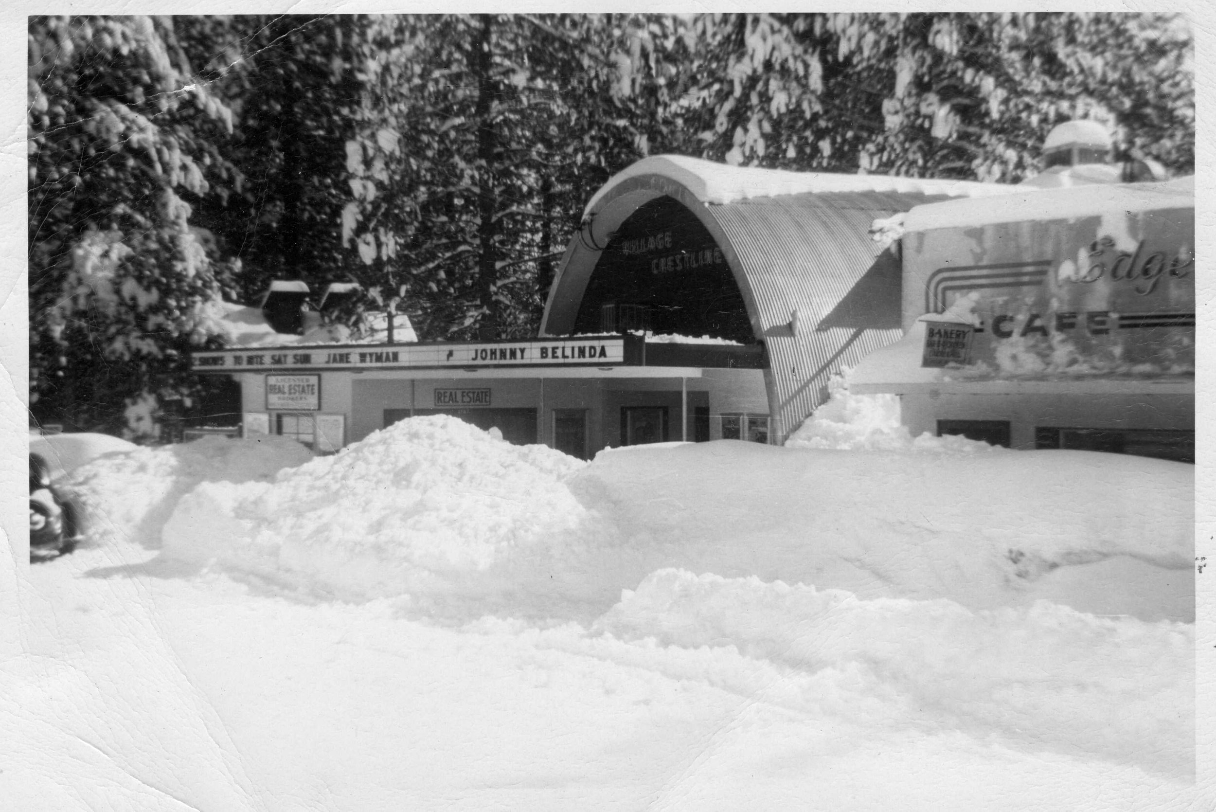 The Village Theatre surrounded by deep snow, with Johnny Belinda on the marquee