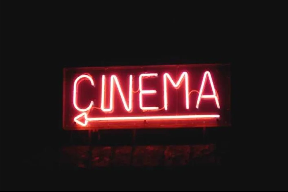 A neon CINEMA sign