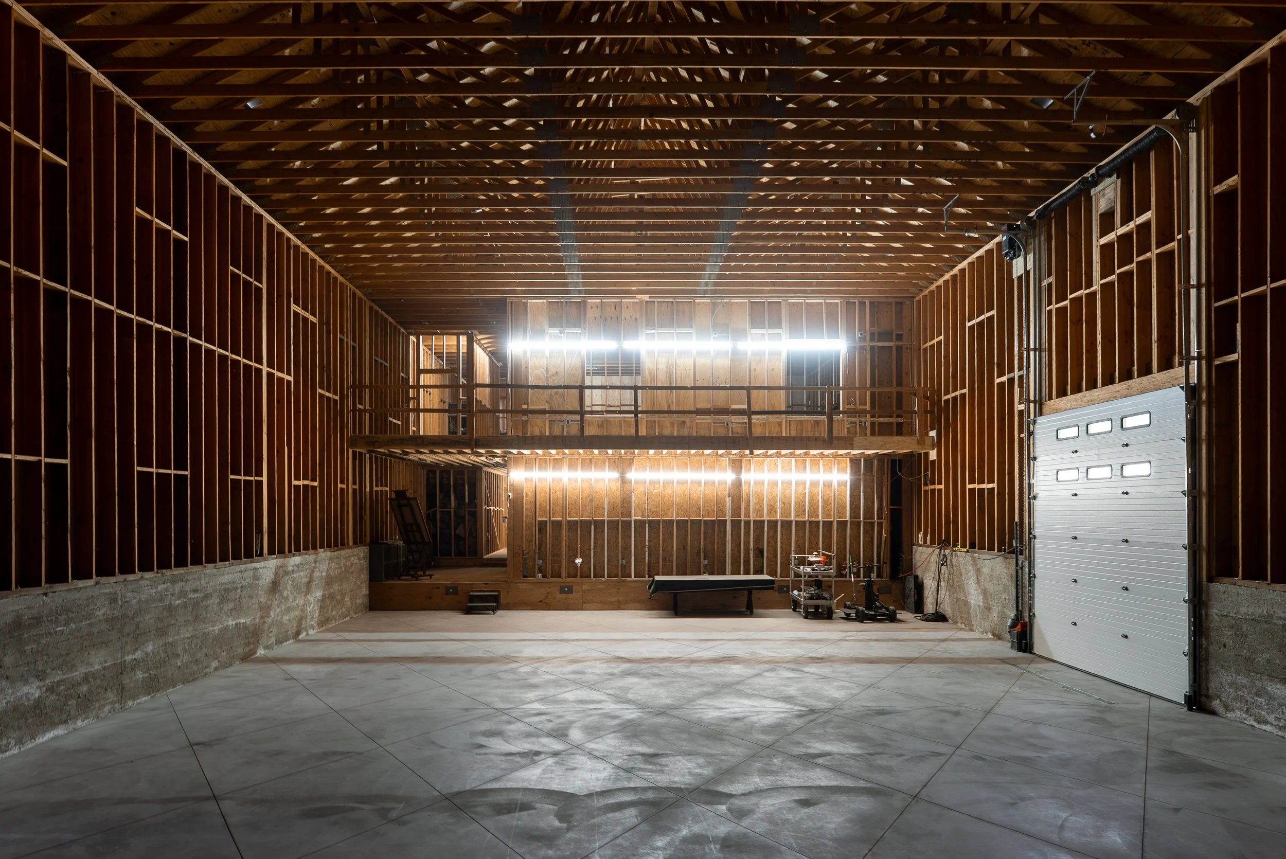 The framed-out hall with timber walls and a mezzanine