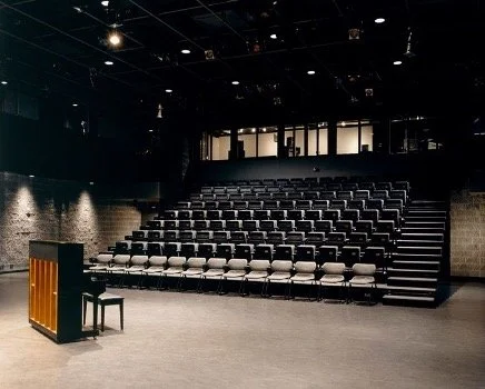 Telescoping seats set up in a black box venue