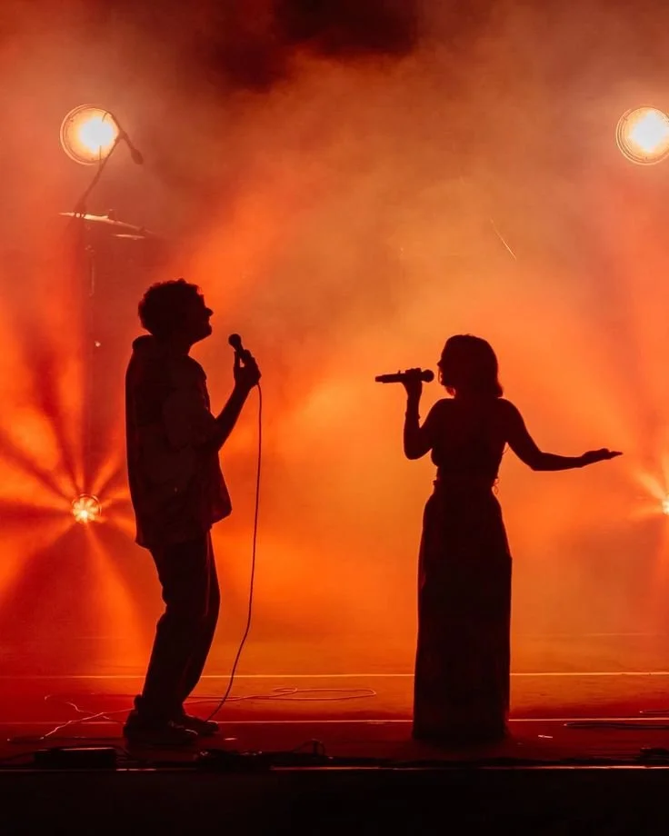 Phones raised at a glowing concert