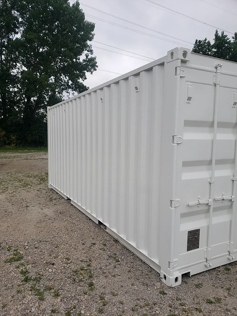 White 20-foot container on a gravel lot, viewed from the side