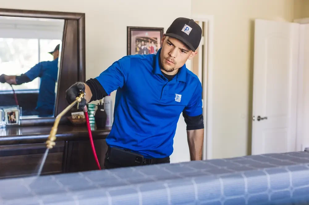 Bed Bugs Arizona treating a bed frame by hand