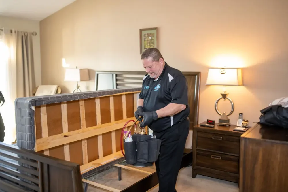 Bed Bugs Arizona treating a bed frame by hand