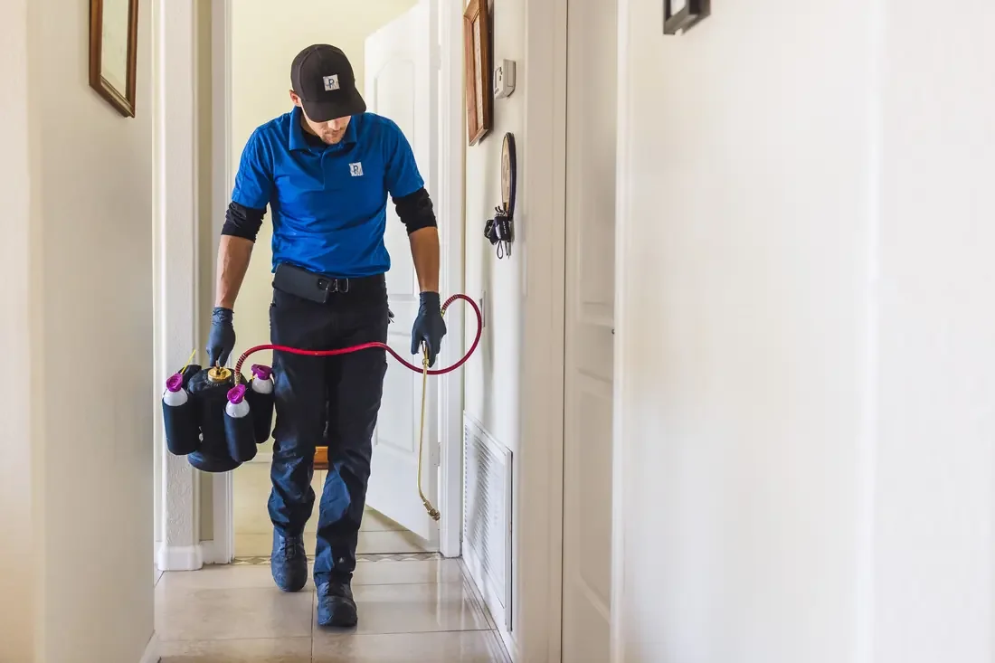 Bed Bugs Arizona technician carrying treatment equipment through a rental unit
