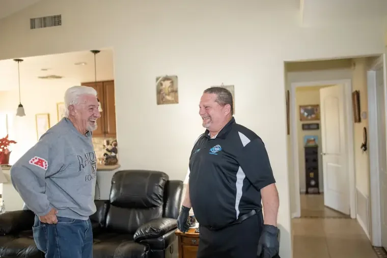 John Taylor shaking hands with a homeowner after a bed bug inspection